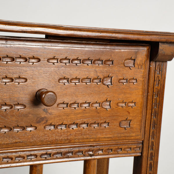 Pair of antique carved accent tables with drawer and stretcher shelf, oak and walnut