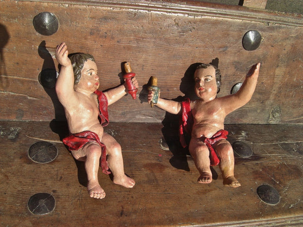 Pair of small carved and painted antique cherubs
