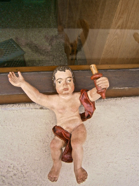 Antique carved and painted cherubs