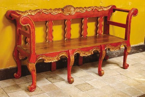 Reproduction carved and upholstered "Cusco" Spanish colonial bench, cachimbo hardwood