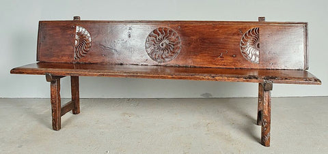 Antique trestle leg walnut bench with carved sun symbols