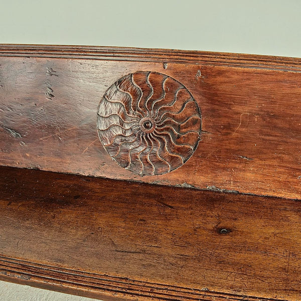Antique trestle leg walnut bench with carved sun symbols