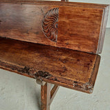 Antique trestle leg walnut bench with carved sun symbols