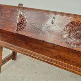 Antique trestle leg walnut bench with carved sun symbols