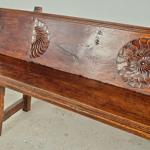 Antique trestle leg walnut bench with carved sun symbols