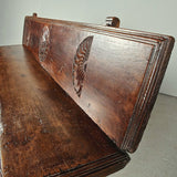 Antique trestle leg walnut bench with carved sun symbols