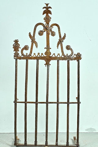 Antique wrought iron window grill with crown