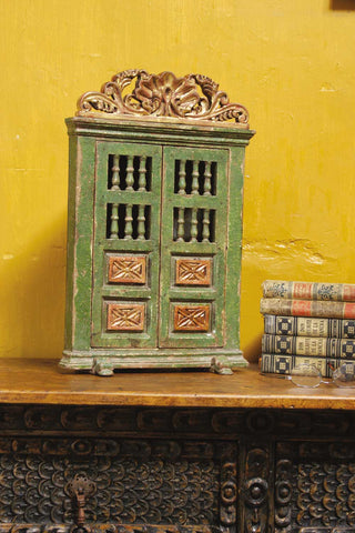 Reproduction carved, polychromed, and gilt mini corner cabinet.